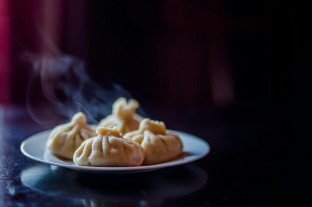 Delicious steamed dumplings with a savory filling served on a ceramic plate, showcasing Asian cuisine.